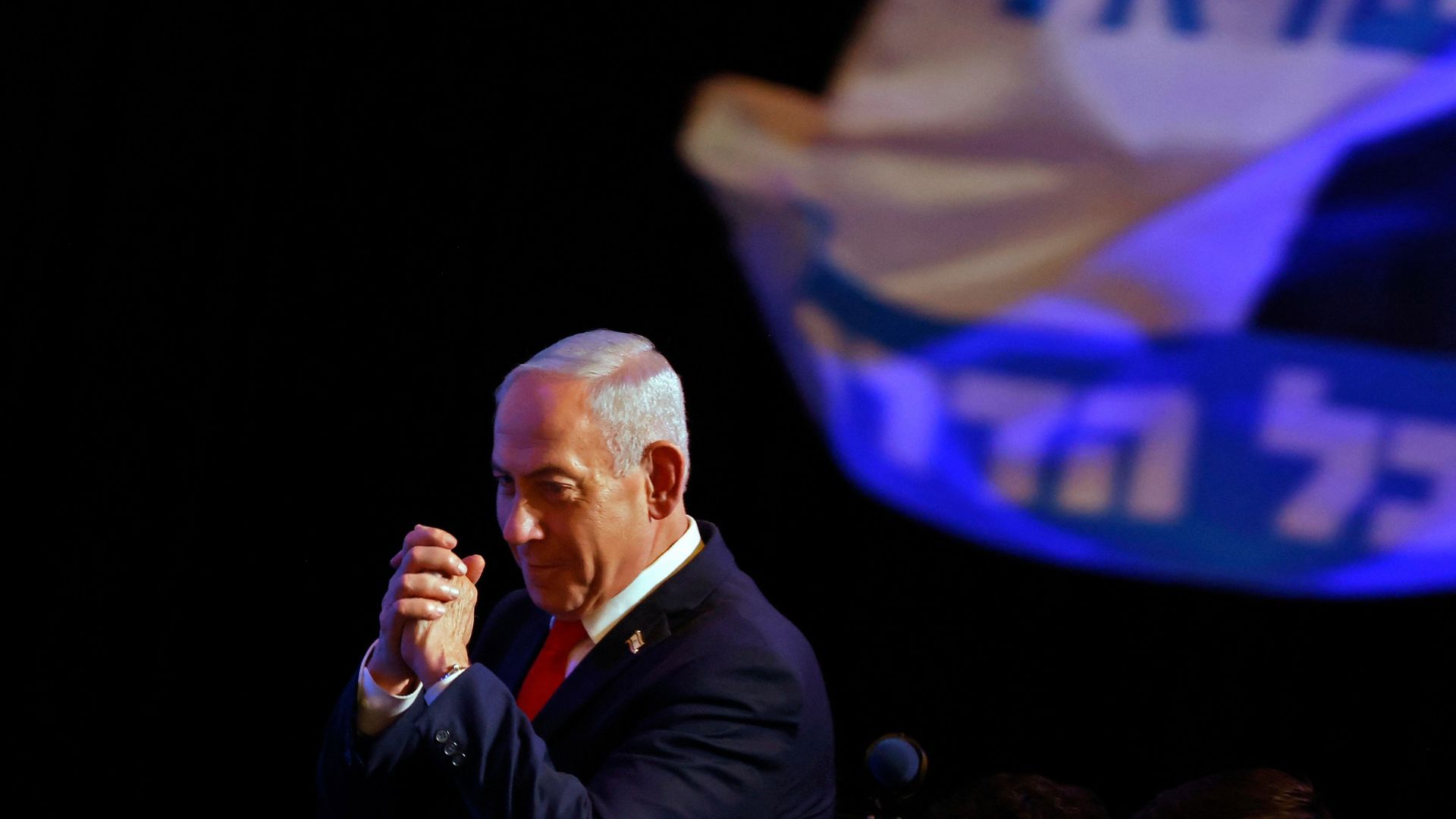 Israeli Prime Minister Benjamin Netanyahu gestures to his supporters at an election night rally in Jerusalem. /Jalaa Marey/AFP