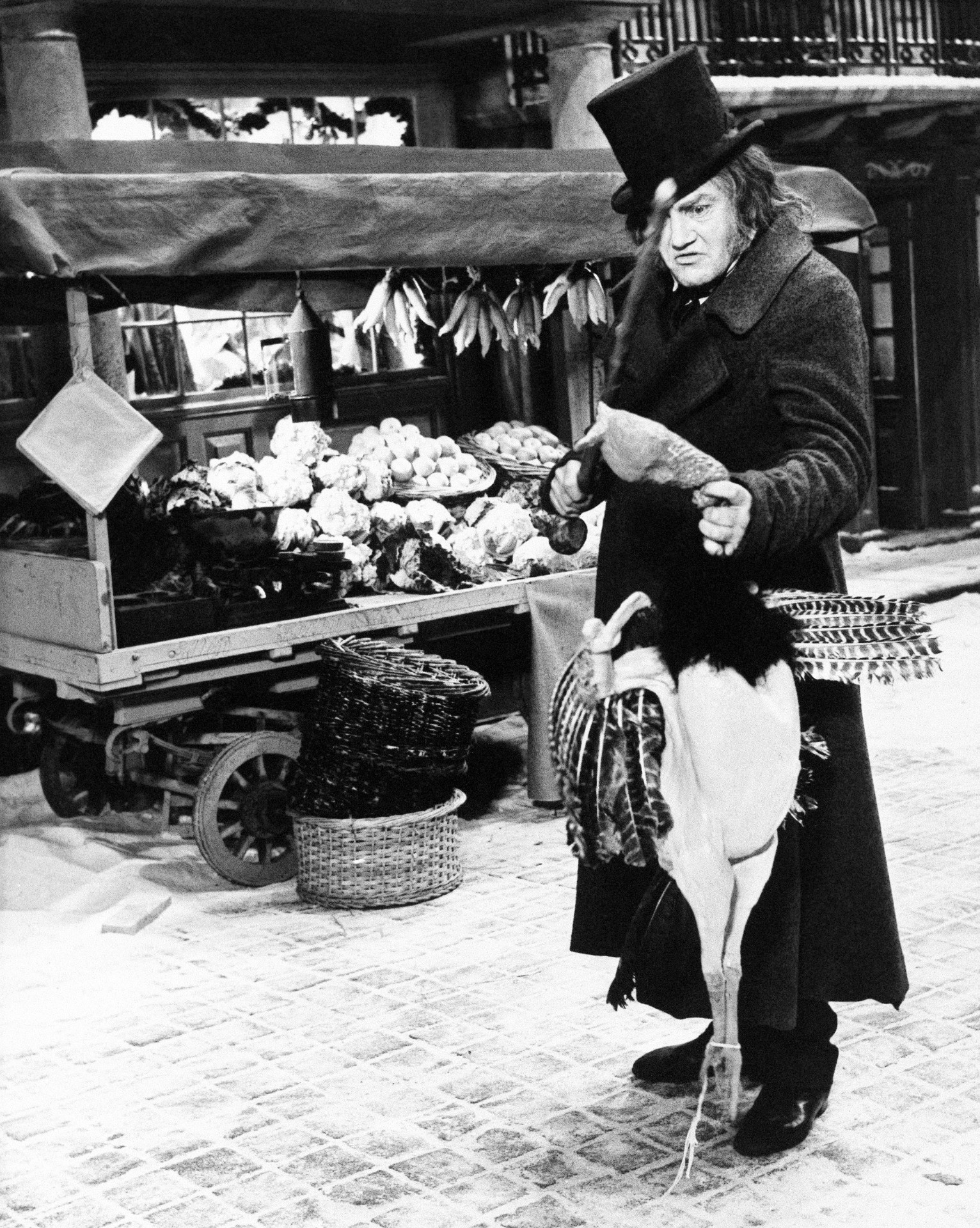 Albert Finney, as Scrooge, examines a turkey in the 1970 musical film of the story. /R. Dear/AP Photo
